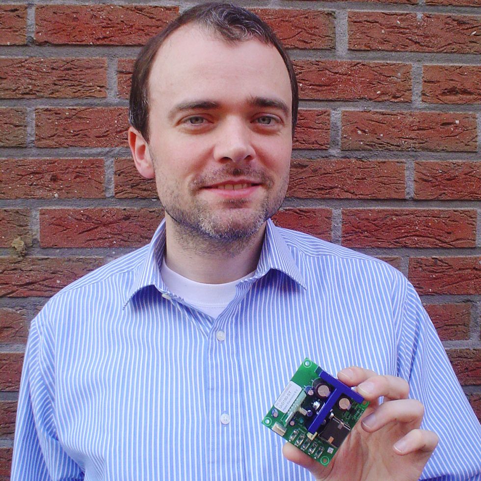 Bruno Putzeys holds an early Universal Class-D audio amplifier manufactured by Hypex Electronics.