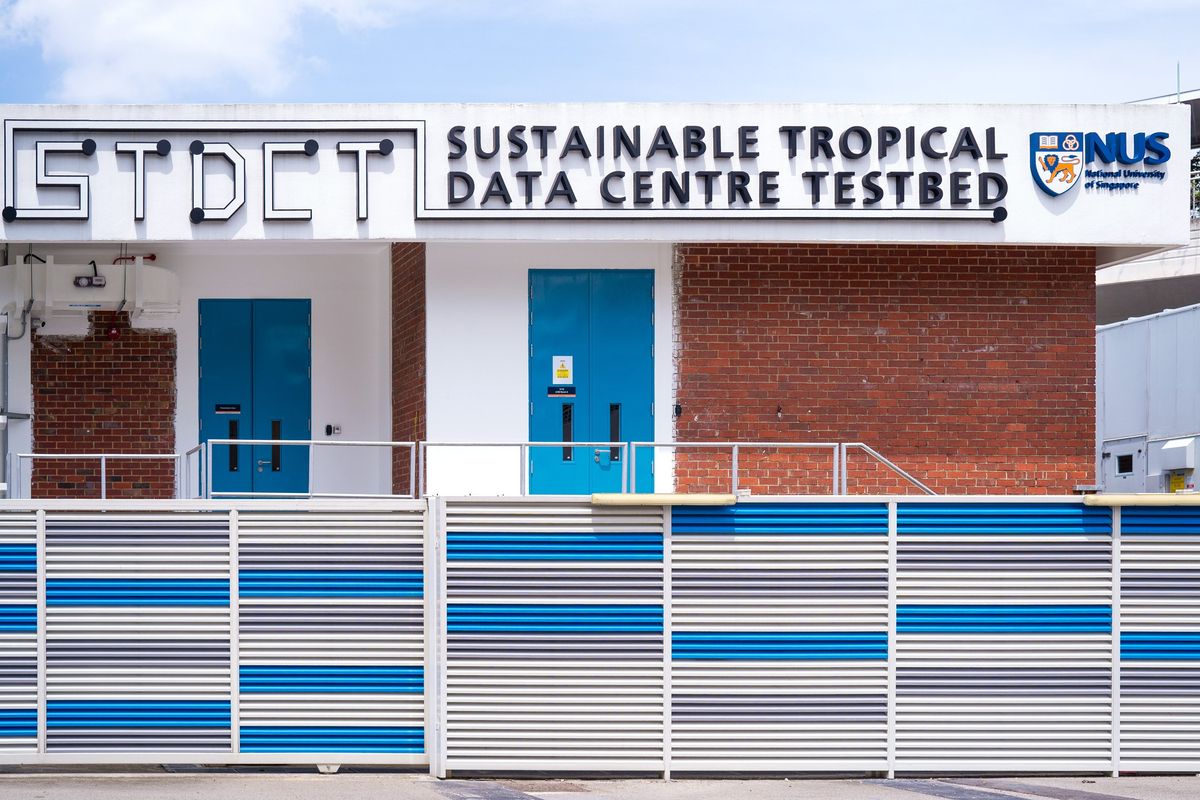 building facade with blue and white stripes, blue doors and writing on top
