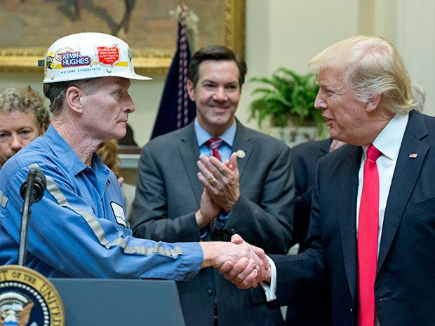 Photograph of President Trump shaking hand of hard-hat-wearing coal miner