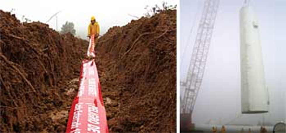 Cables being placed in a ditch in the San Cristobal island, and a crane lifting a tall wind turbine tower.