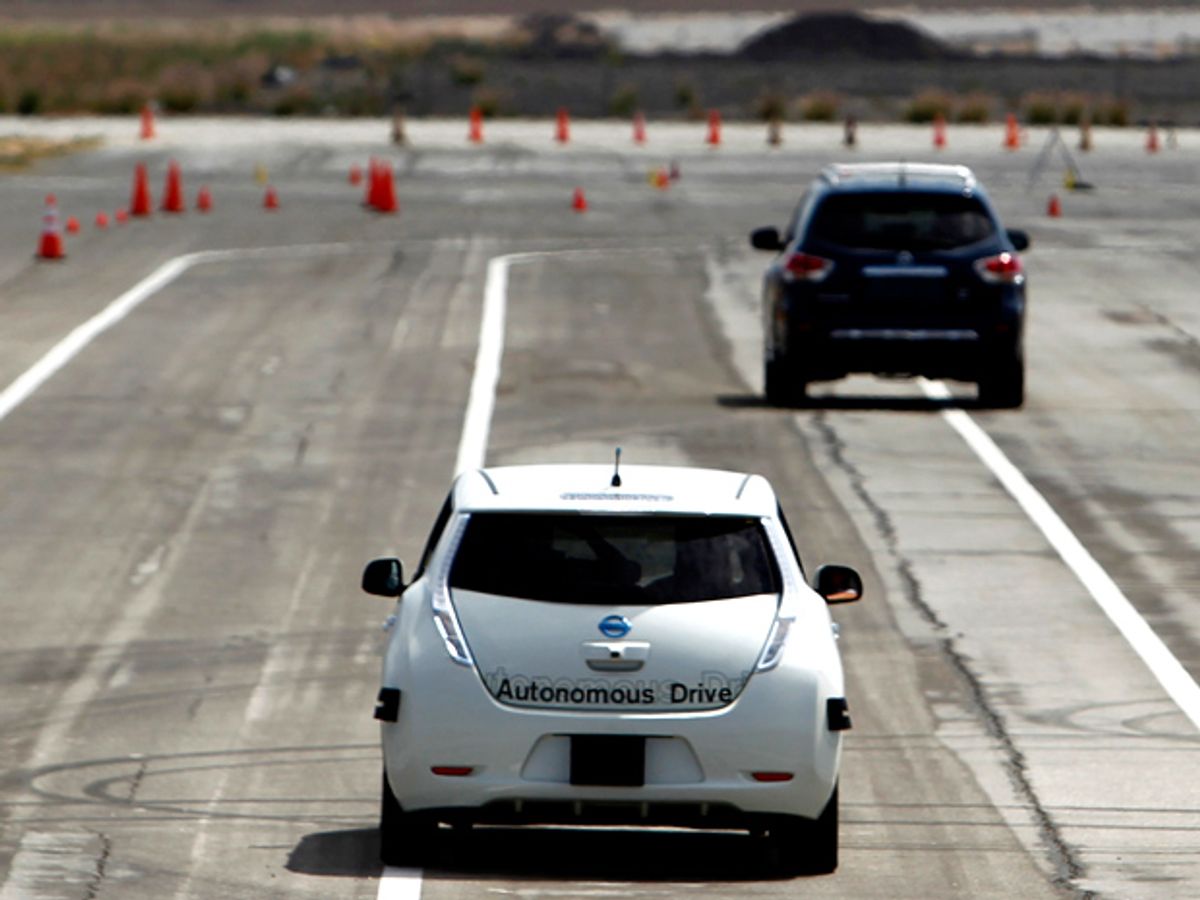 Cars on a large, lined expanse of asphalt with orange traffic cones in the distance.