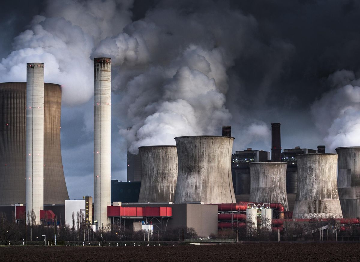 Chimneys and cooling towers from a coal fired power station releasing smoke and steam into the atmosphere.