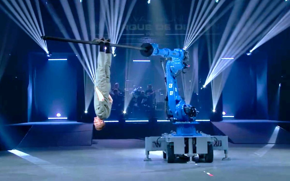 Circus artist Martin Riedel performs with an industrial robot arm at Festival Mondial du Cirque de Demain 2018 in Paris.