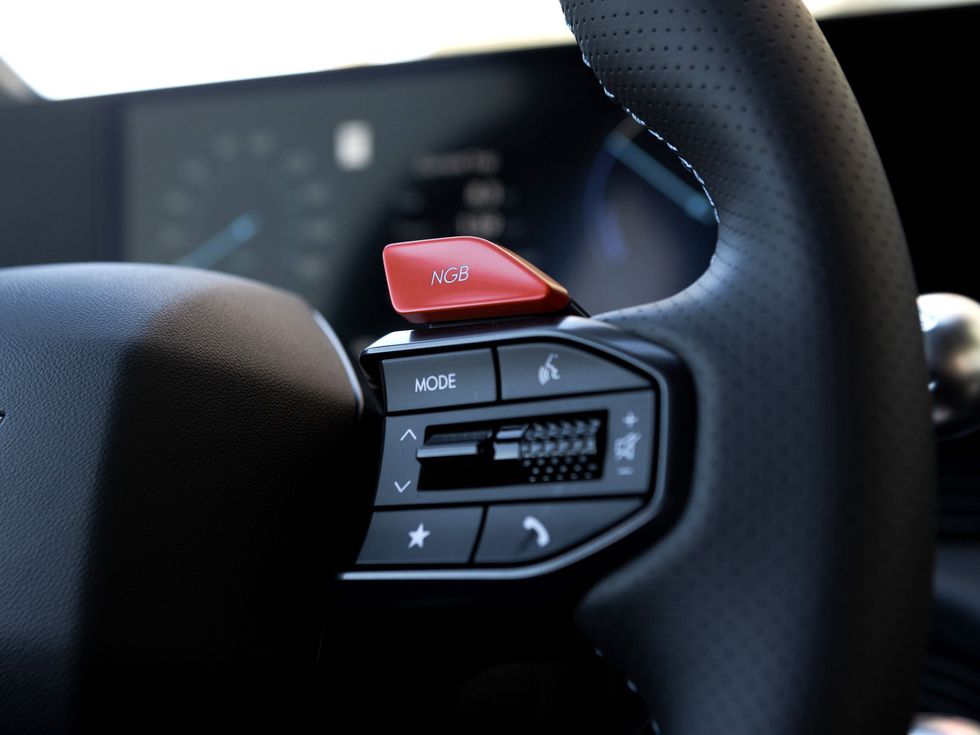 close-up of buttons on a car steering wheel that are black and red