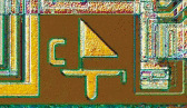 Close-up view of a microchip circuit with a geometric design pattern.