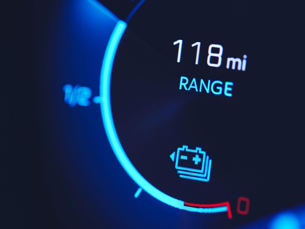 dashboard lights reading 118 miles range with battery symbol