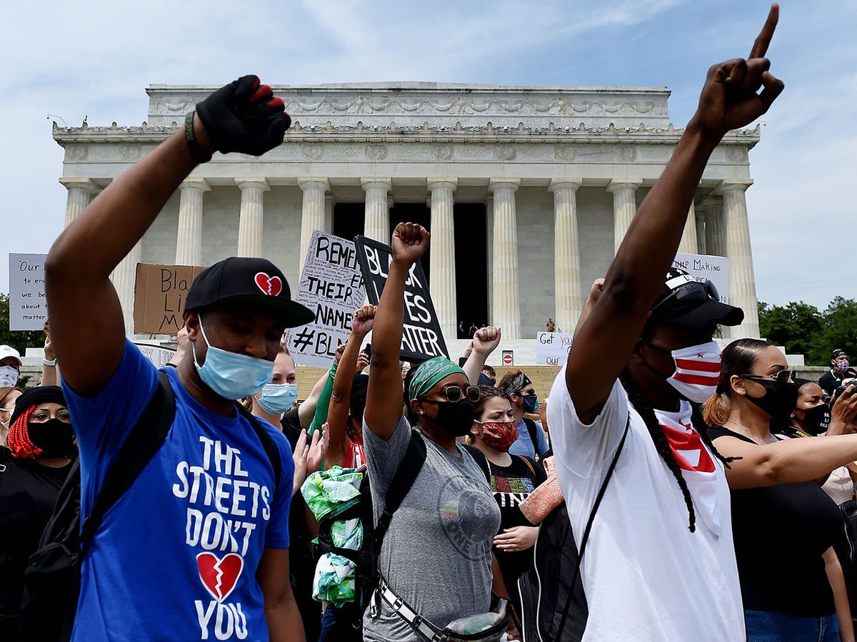 Demonstrators raise their fists at the Lincoln Memorial during a protest against police brutality and racism on June 6, 2020 in Washington, DC.