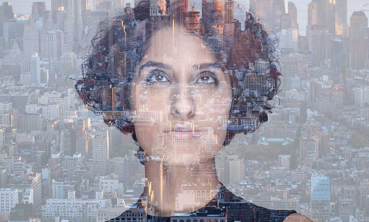 Double exposure of a woman and a city