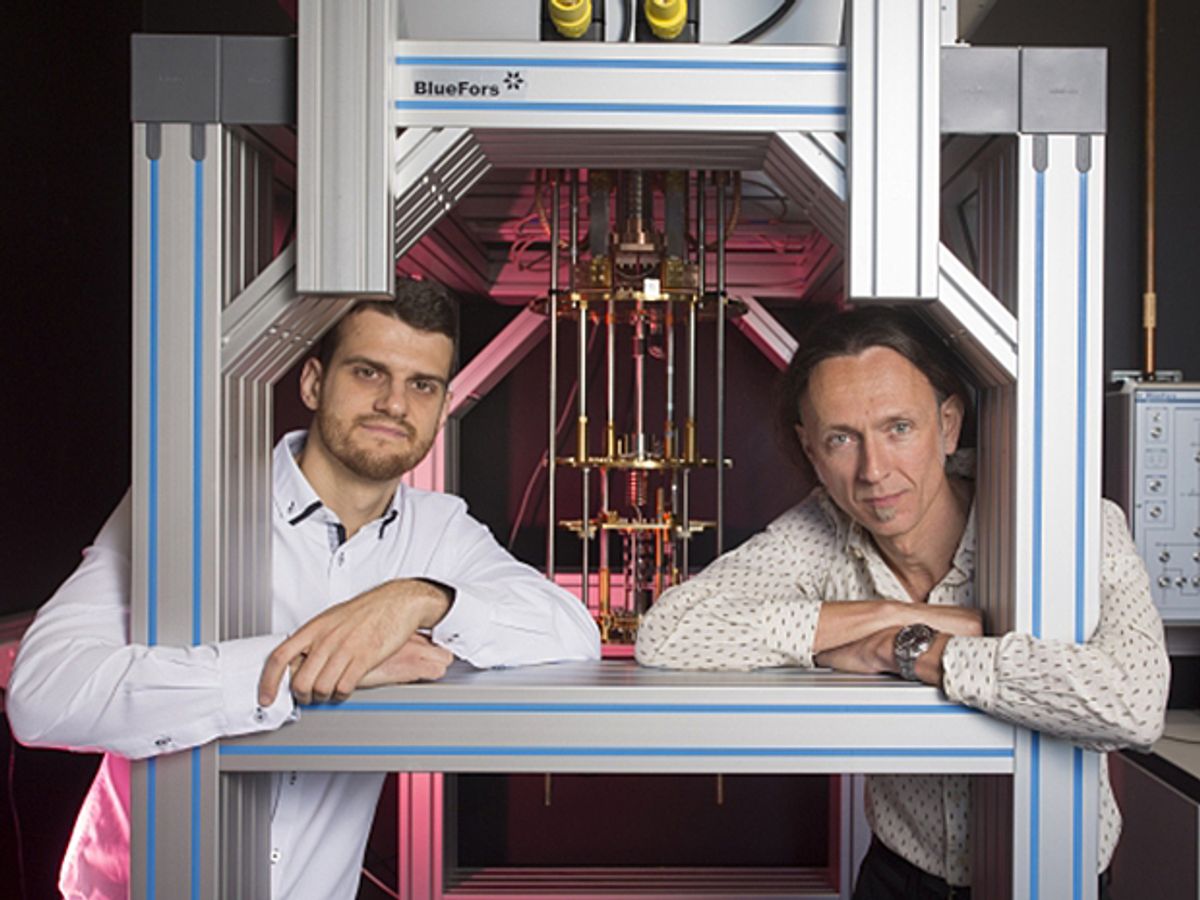 Dr. Guilherme Tosi and Professor Andrea Morello at the University of New South Wales quantum computing labs with a dilution refrigerator, which cools silicon chips down to 0.01 ̊ above absolute zero. 