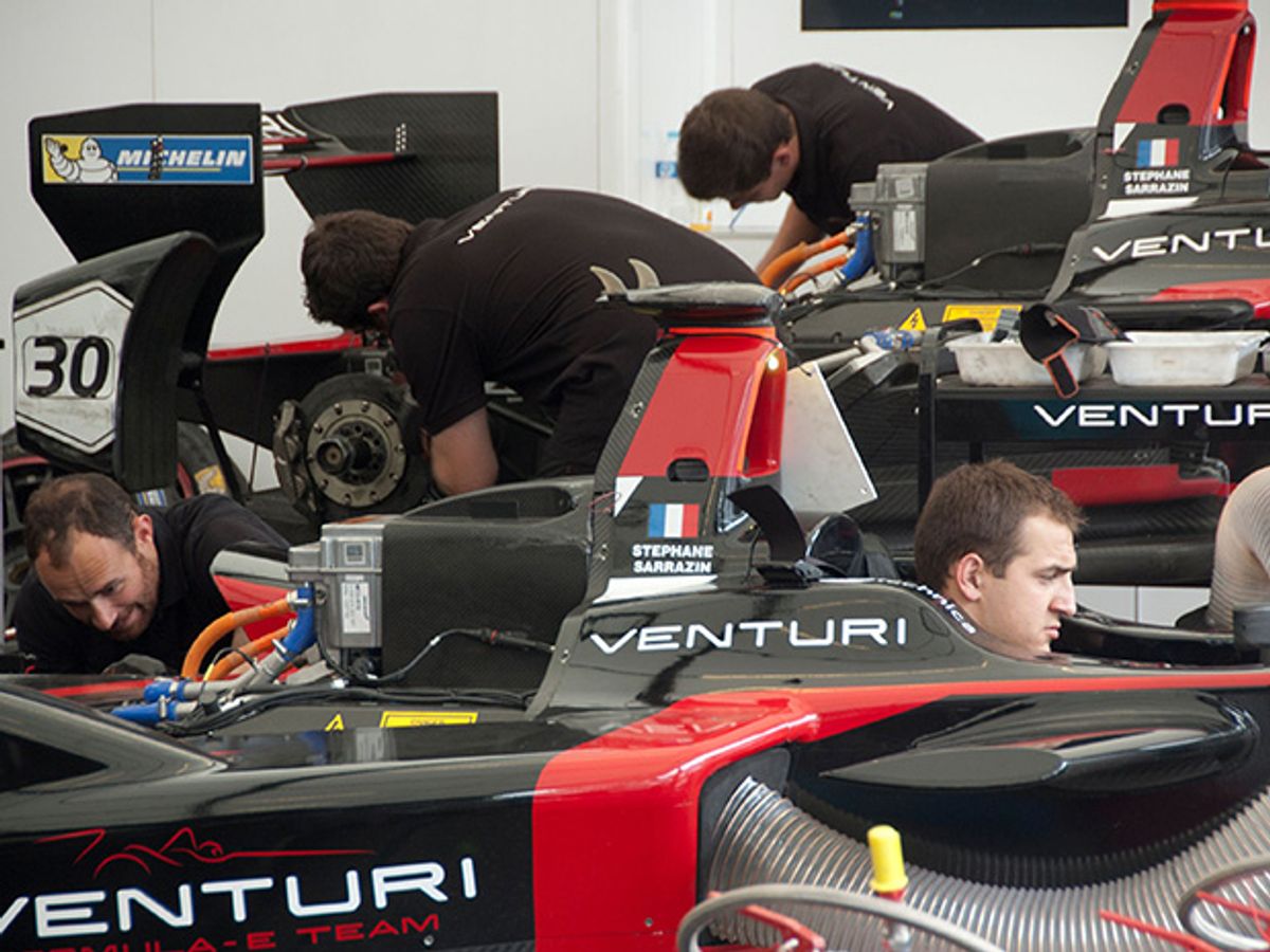 Drivers and mechanics around Formula E cars