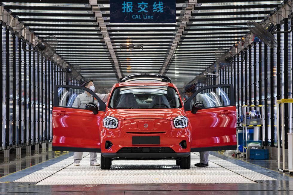 Employees work on the assembly line of T03 electric small crossover at a factory of Chinese EV startup Leapmotor on April 26, 2022 in Jinhua, Zhejiang Province of China. 