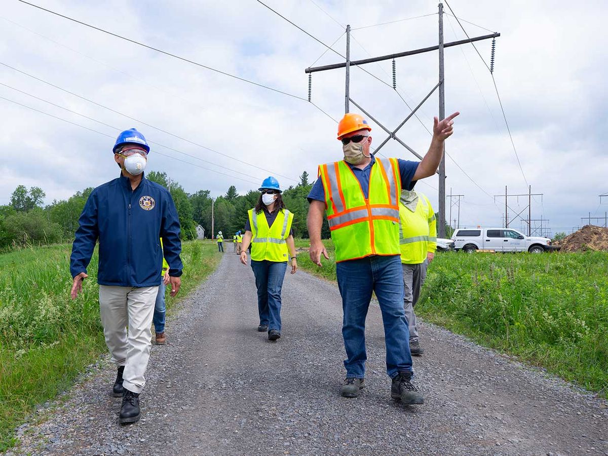 Executives from the New York Power Authority observe progress on a transmission-line project.