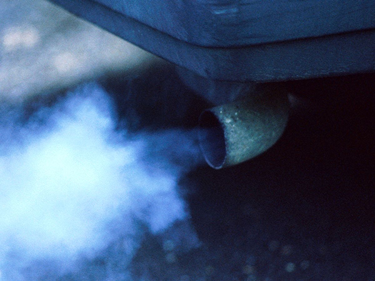 Exhaust comes out of the tailpipe of a vehicle