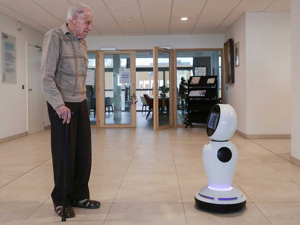 In Ostend, Belgium, ZoraBots brought one of its waist-high robots, equipped with cameras, microphones, and a screen, to a nursing home, allowing residents like Jozef Gouwy to virtually communicate with loved ones despite a ban on in-person visits