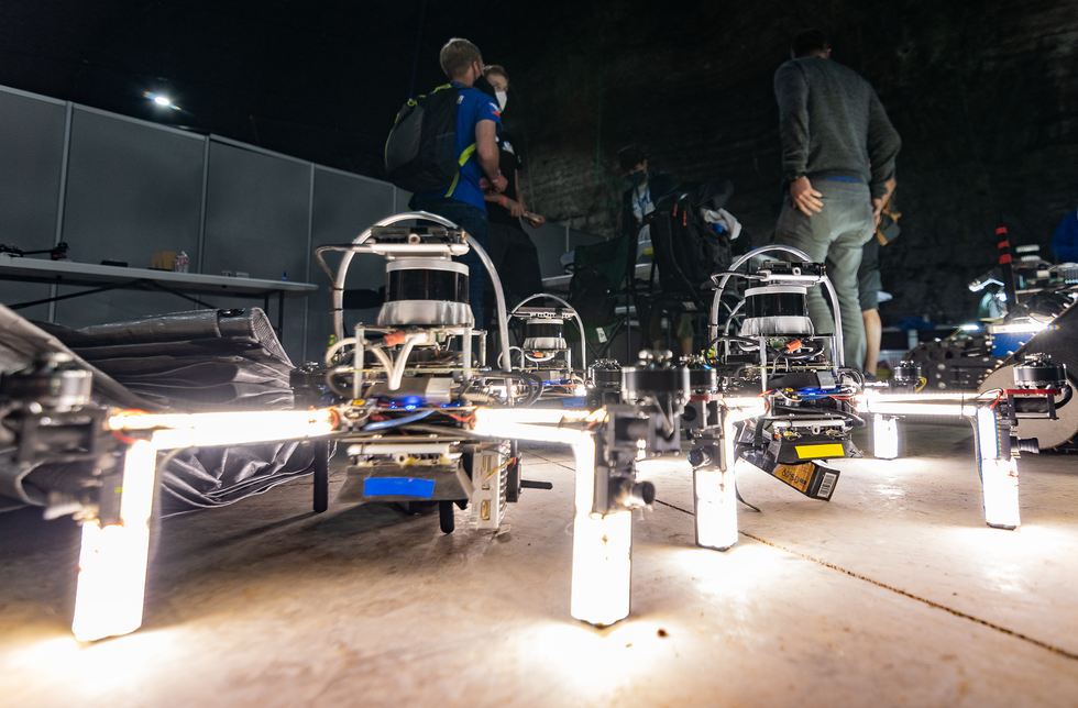 Drones sitting on the ground with very bright lights