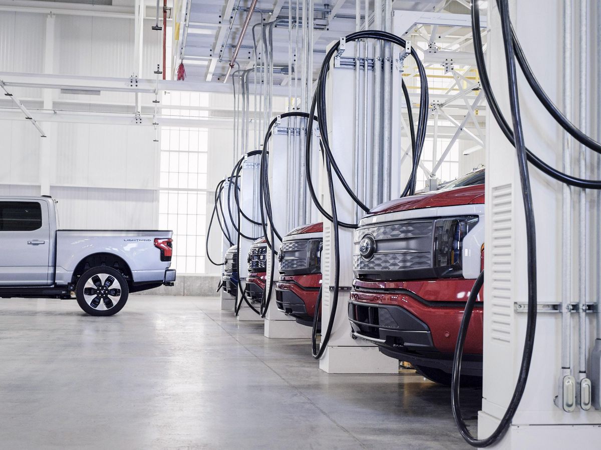 F-150 Lightnings parked at charging stations at the Rouge Electric Vehicle Center in Dearborn, Michigan