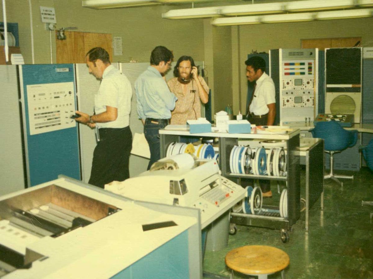 Four men stand in UCLA’s 3420 Boelter Hall in the 1960s