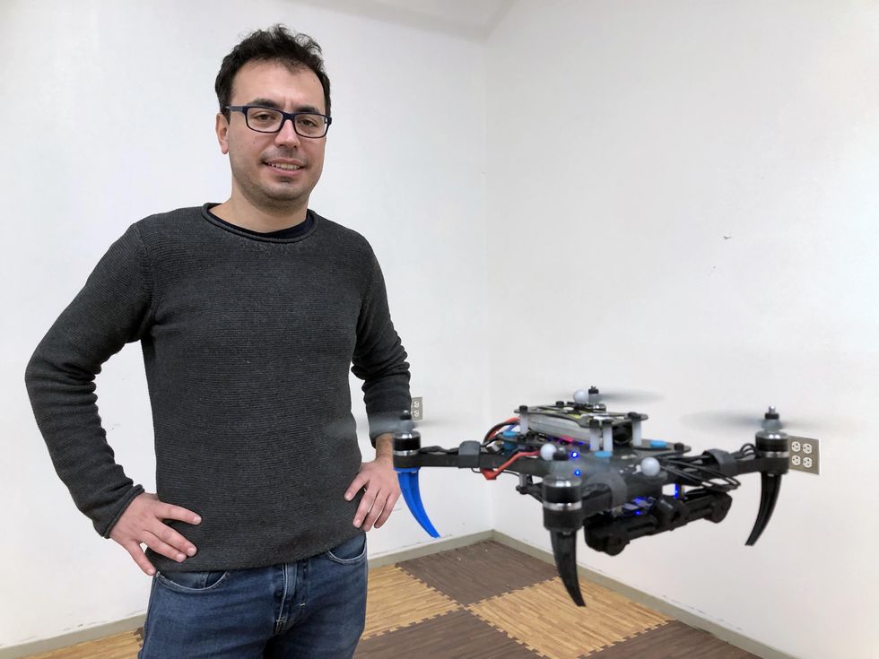Giuseppe Loianno with a drone designed and built in his Agile Robotics and Perception Lab at NYU Tandon.