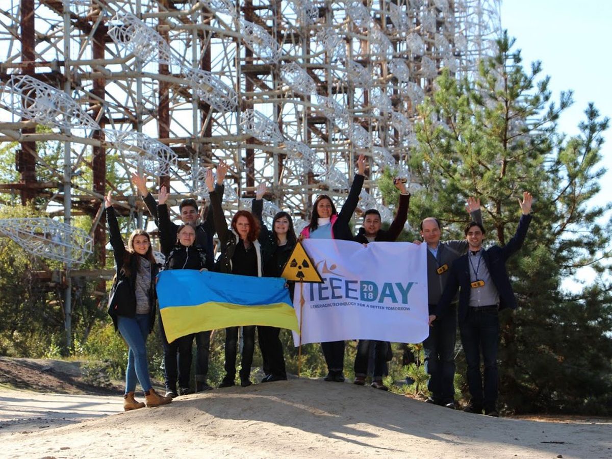Group of individuals holding up a 2018 IEEE Day sign.