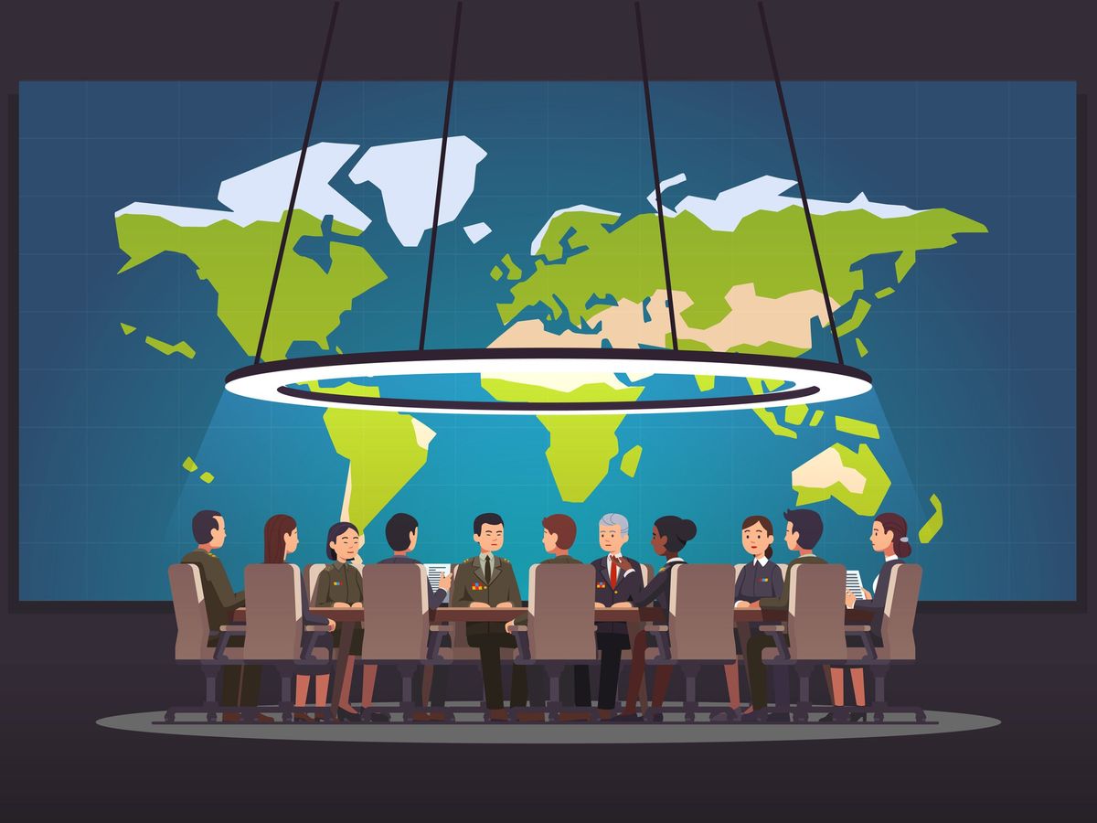 group of people in a meeting sitting around a table in front of a world map