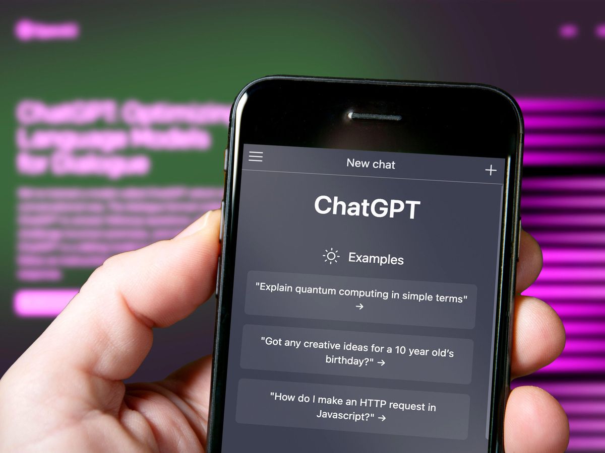 hand holding smartphone with ChatGPT examples on the screen