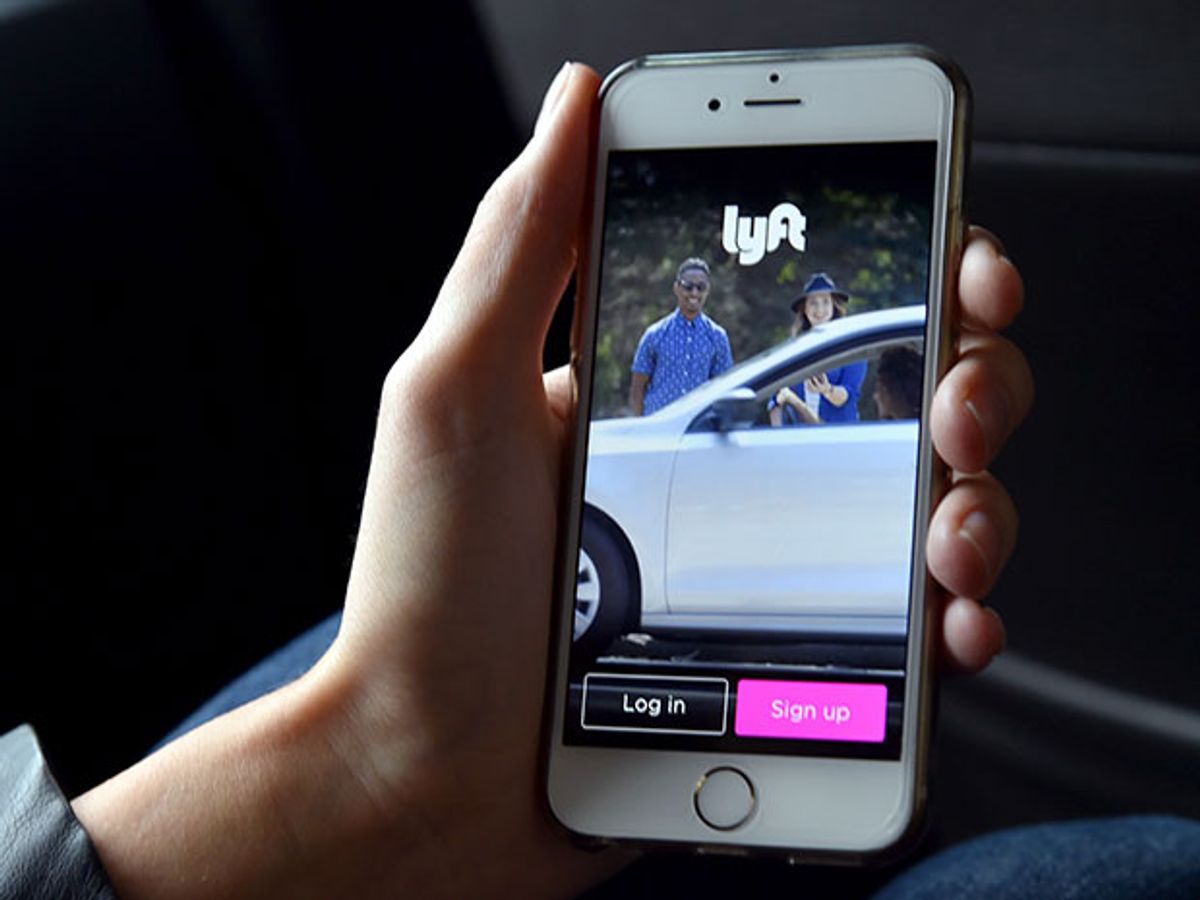 hand holding smartphone with lyft app displayed