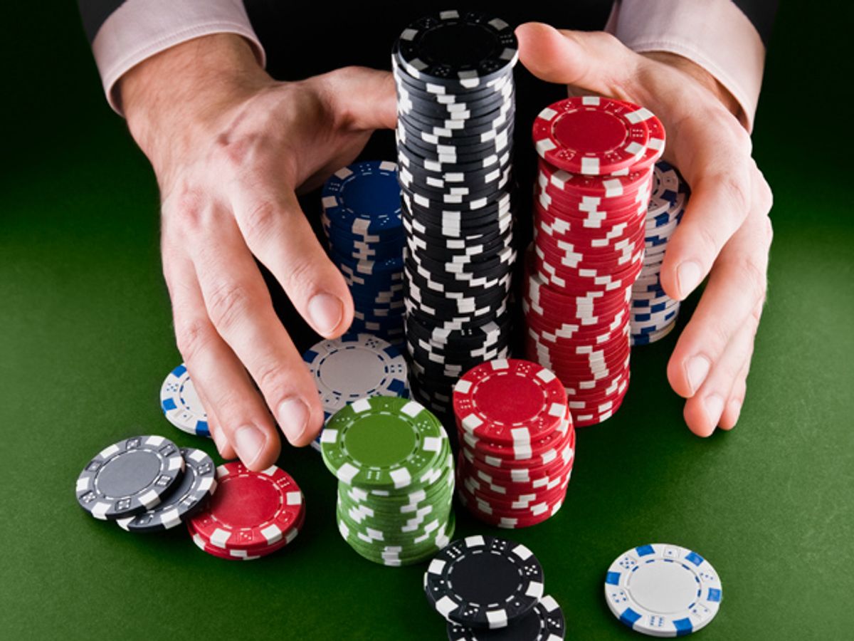 Hands holding a bunch of poker chips.