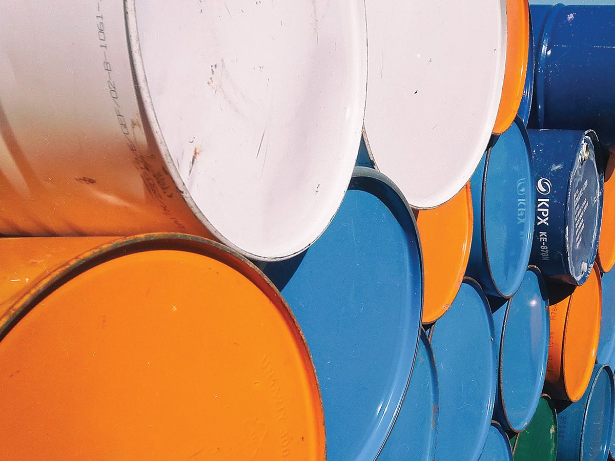 Horizontally stacked colored oil cans.