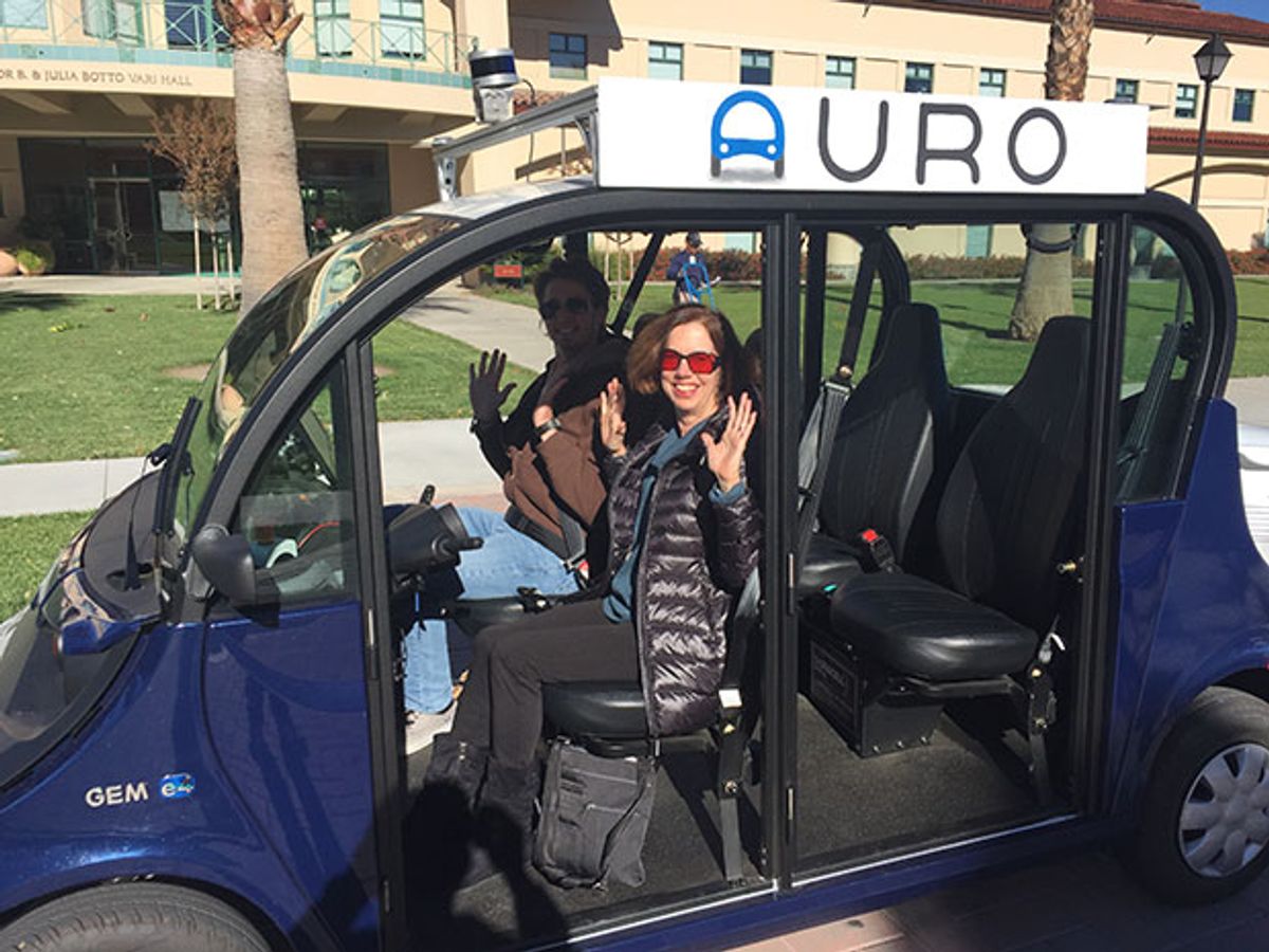 IEEE Spectrum senior editor Tekla Perry sits in what would be the drivers' seat, if Auro's self-driving shuttle at Santa Clara University had a driver