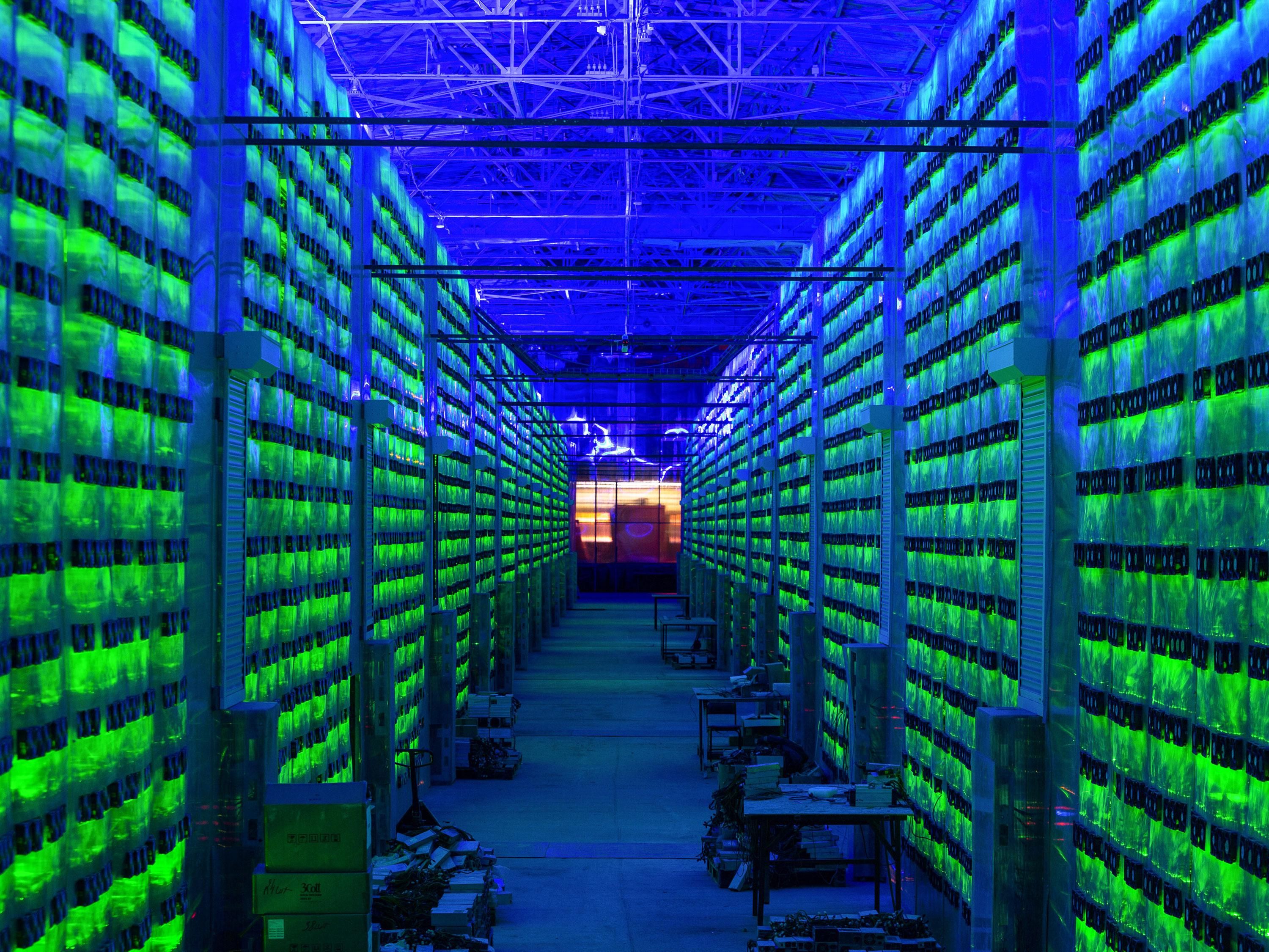illuminated cryptocurrency mining farm racks in Russia.
