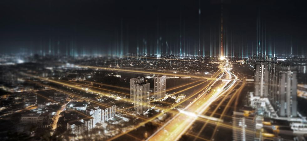 Illustration of a city at night with bright lights