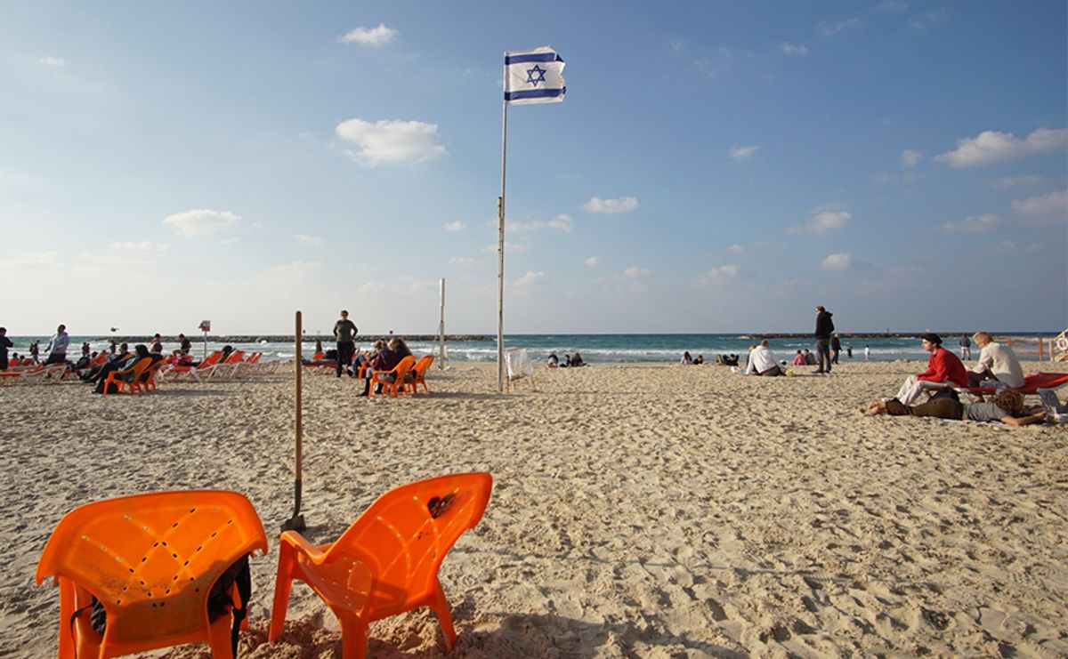 Image of a beach with the Israeli flag as the focal point.