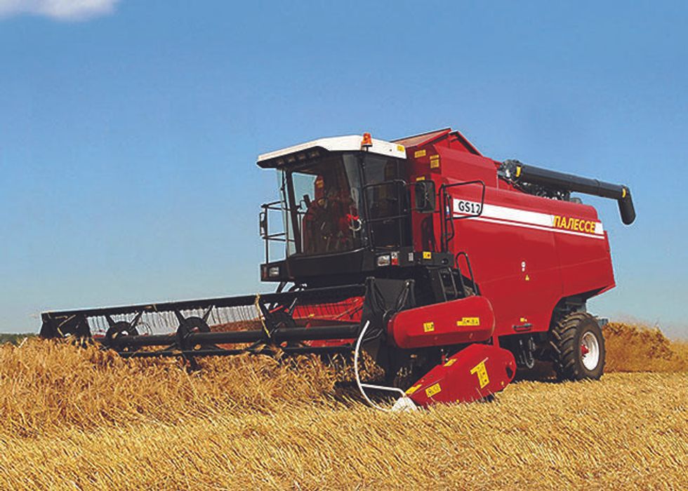 Image of a combine harvester, harvesting wheat crops.