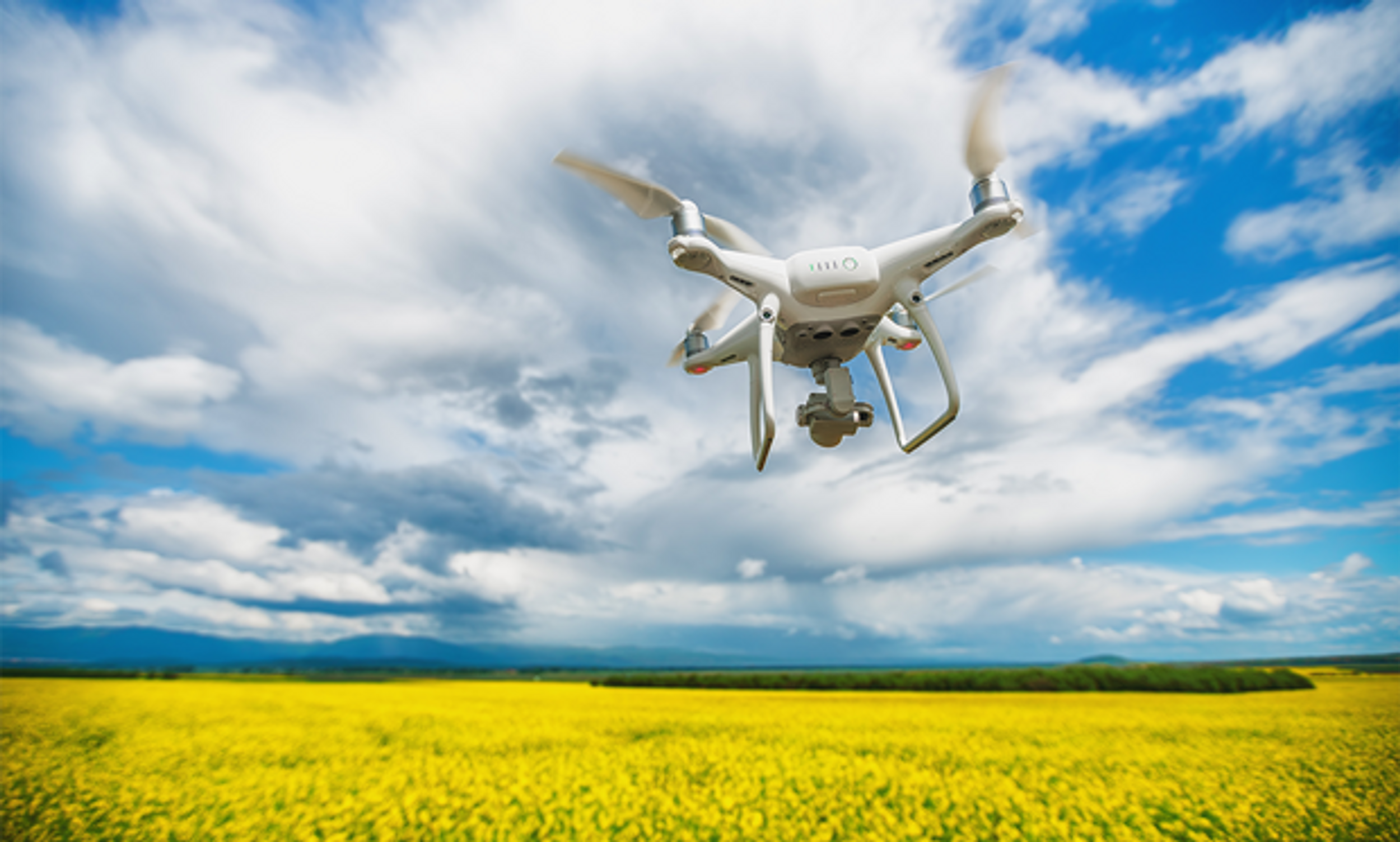 Image of a drone flying above a field