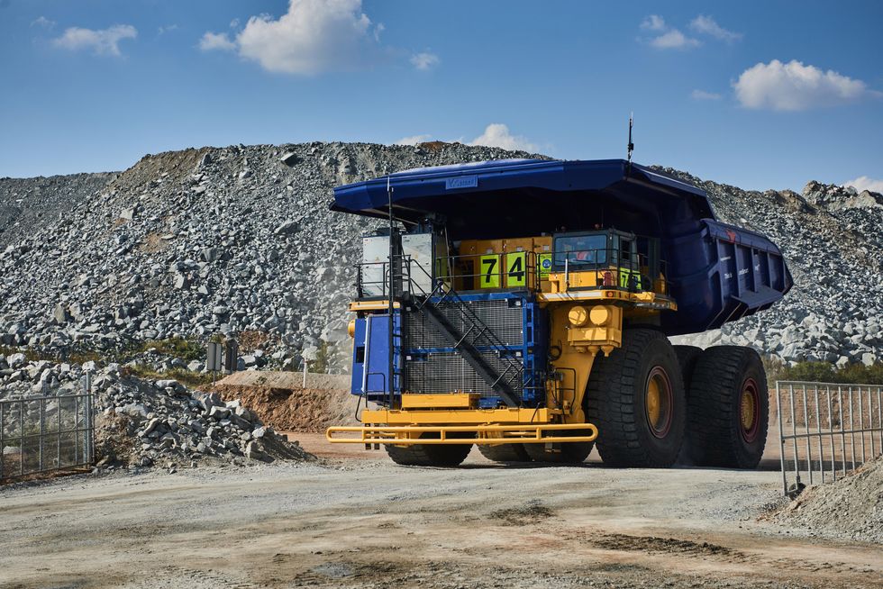 Image of Anglo American's mining truck driving within a junkyard.