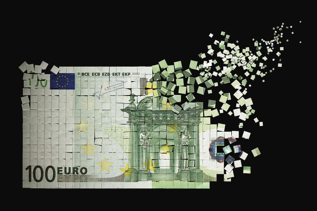 Image of Euro bill breaking apart.