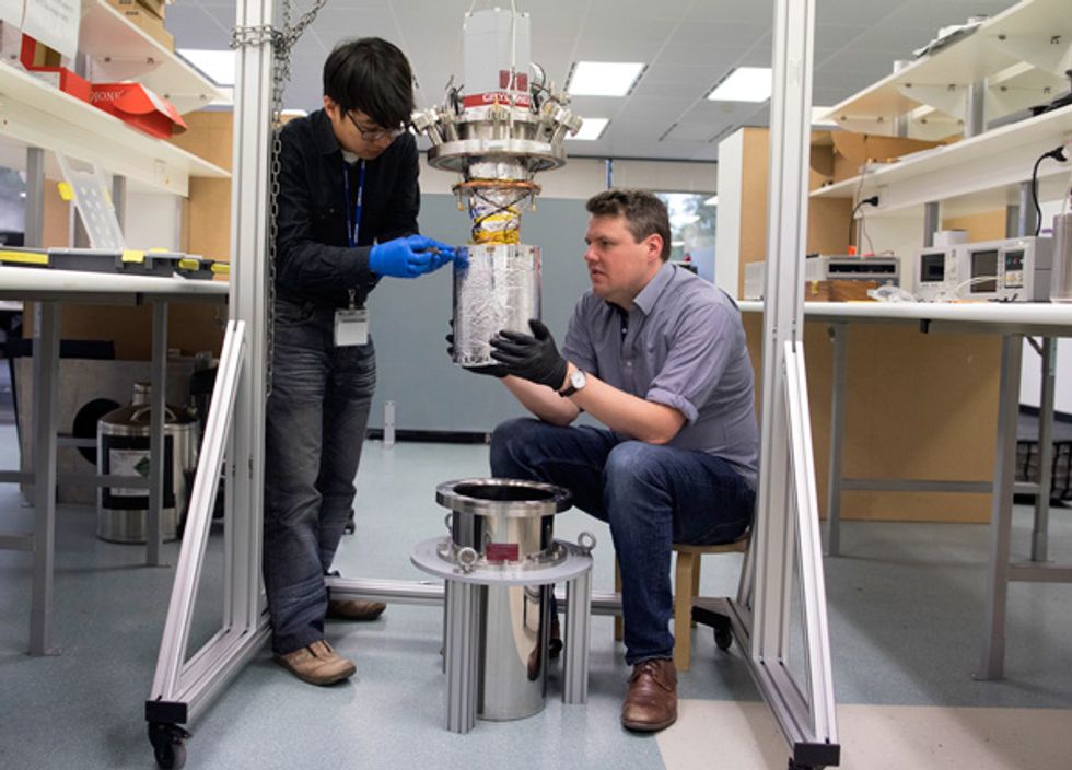 Image of Ka Wu and Fred Baynes, lowering the crystal into a cryogenic cooler.