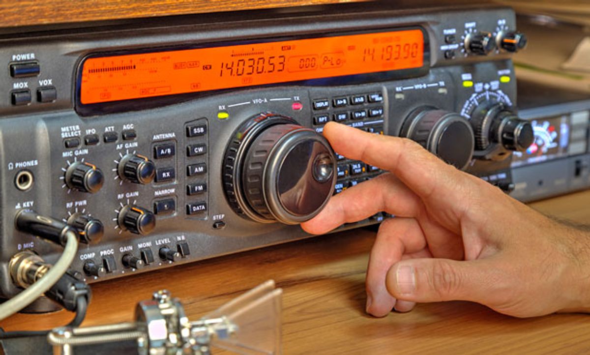 Image of someone adjusting a radio transmitter