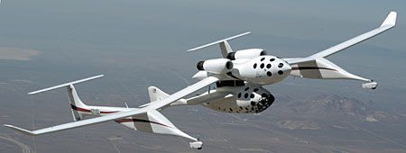 Burt Rutan's SpaceShipOne rocket is cradled below a turbojet aircraft