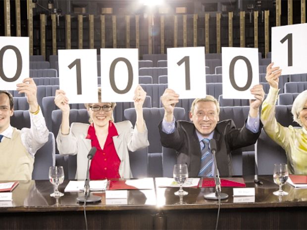 stock photo of people holding up cards with numbers