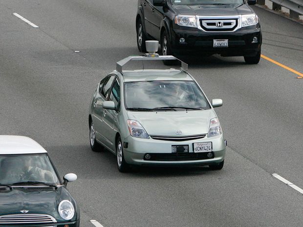 An autonomous Prius driving on a highway with other cars.