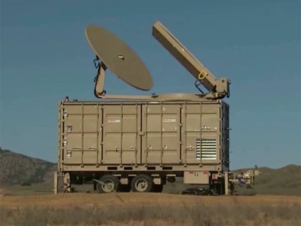 Raytheon Phaser looks like a tan trailer with a flat dish on an arm at top and a rectangle at a 45-degree angle.