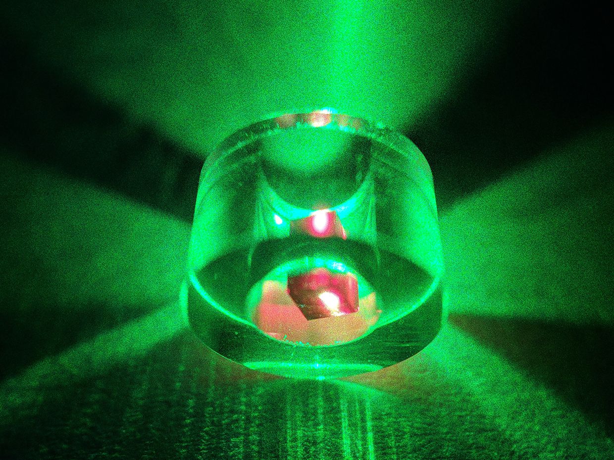 The maser effect appears as a green glow from a laser with the diamond in red
