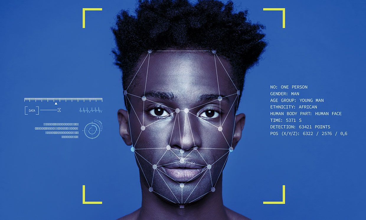 Photo-illustration of a man of color with facial recognition technology reading his face.