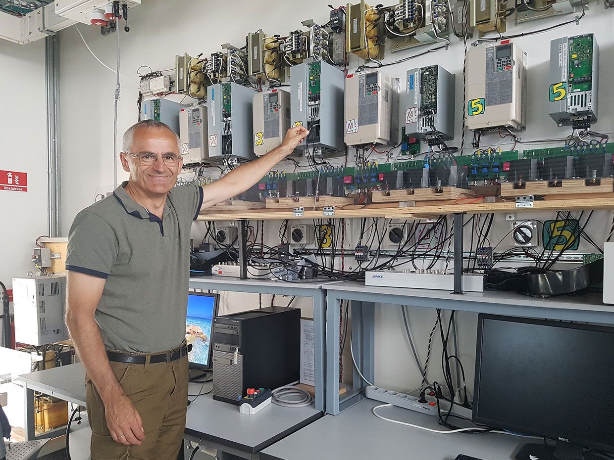 2019 Global Energy Prize laureate Danish professor Frede Blaabjerg in front of a wall of power electronics