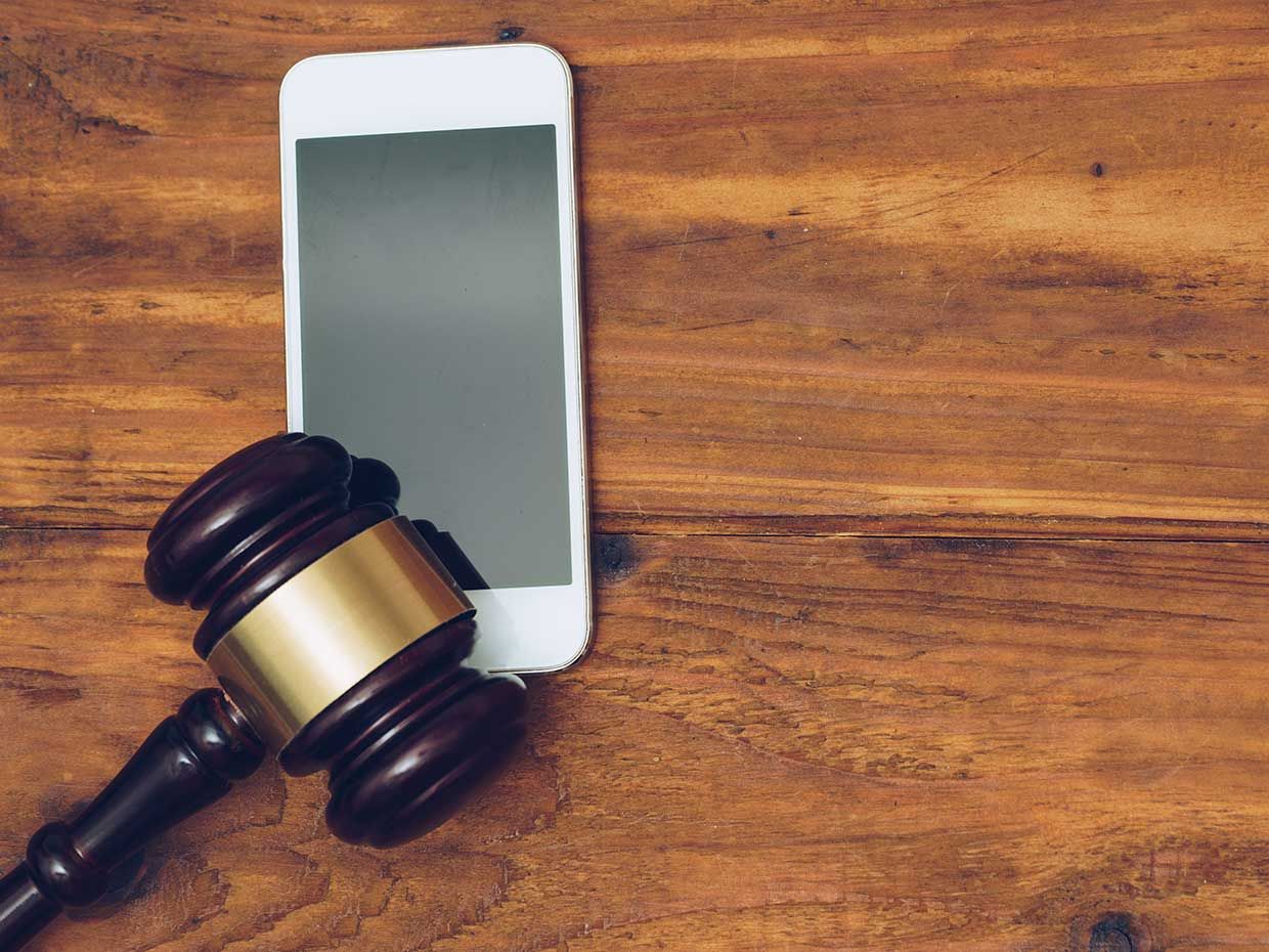 Photo of a gavel and an iPhone