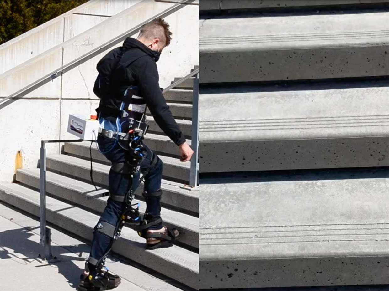A man walking in an exoskeleton up stairs.