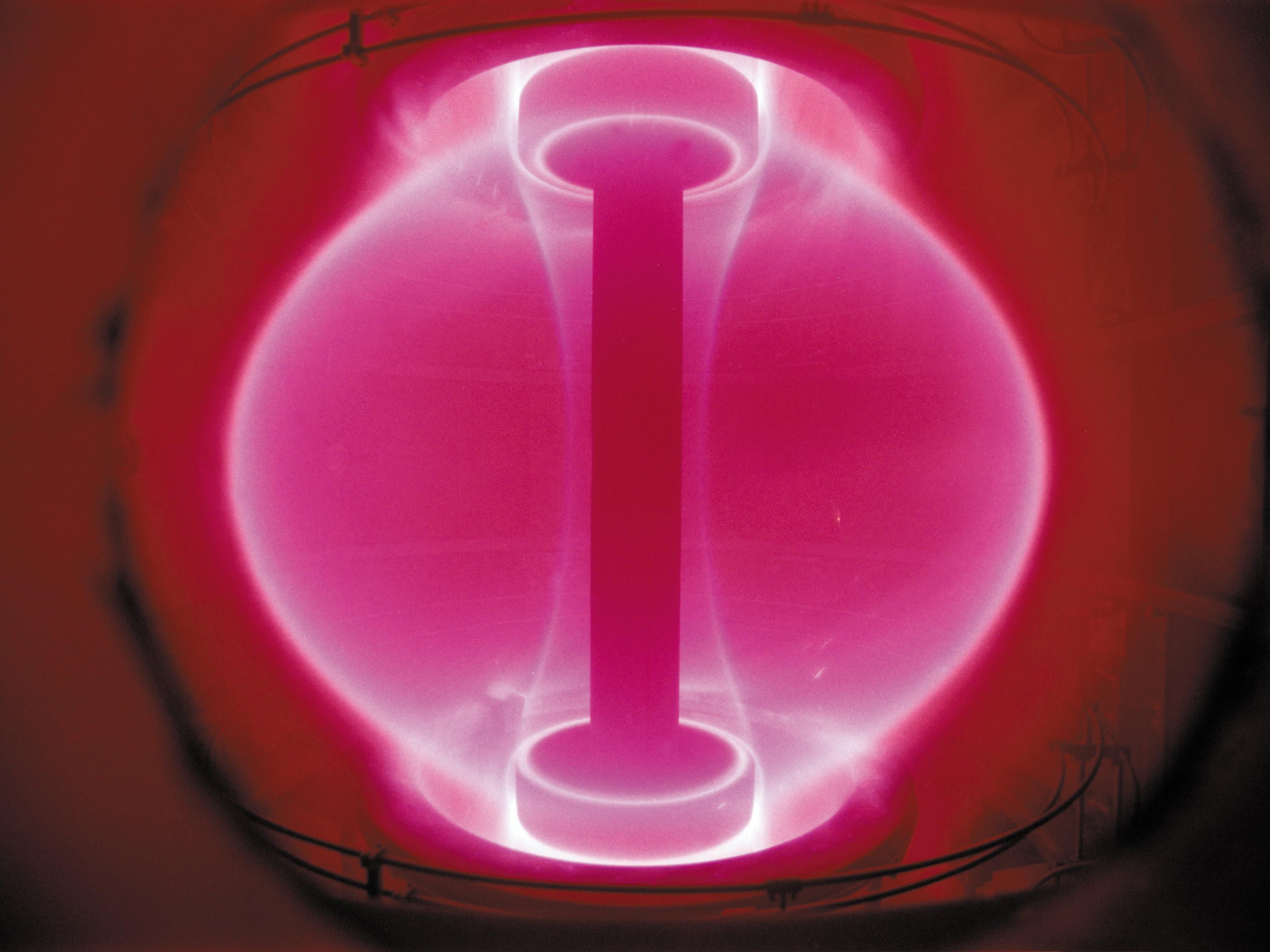 Spherical ball of plasma (pink) in a red colored chamber