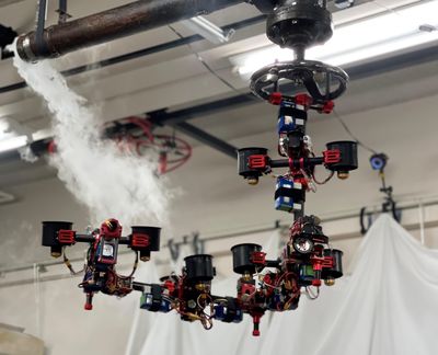 A complex aerial robot made of multiple segments of actuators and ducted fans grasps and turns a valve near a ceiling