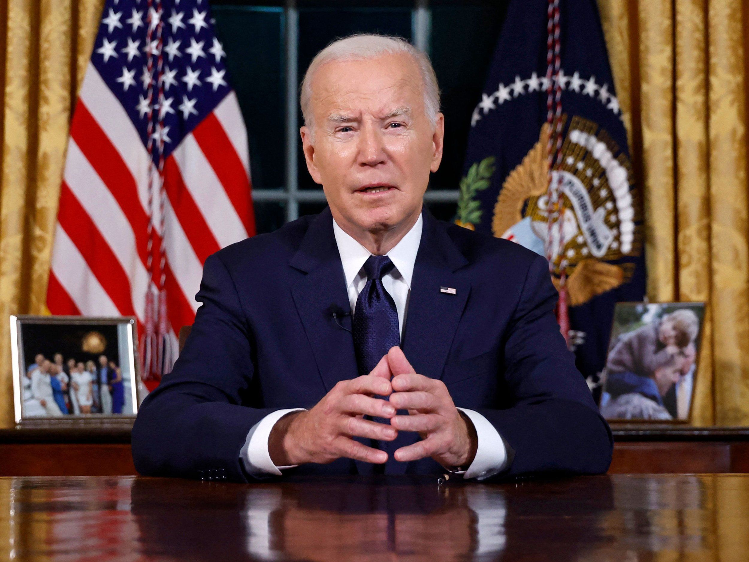 President Joe Biden sitting at a desk with hands together talking to the camera